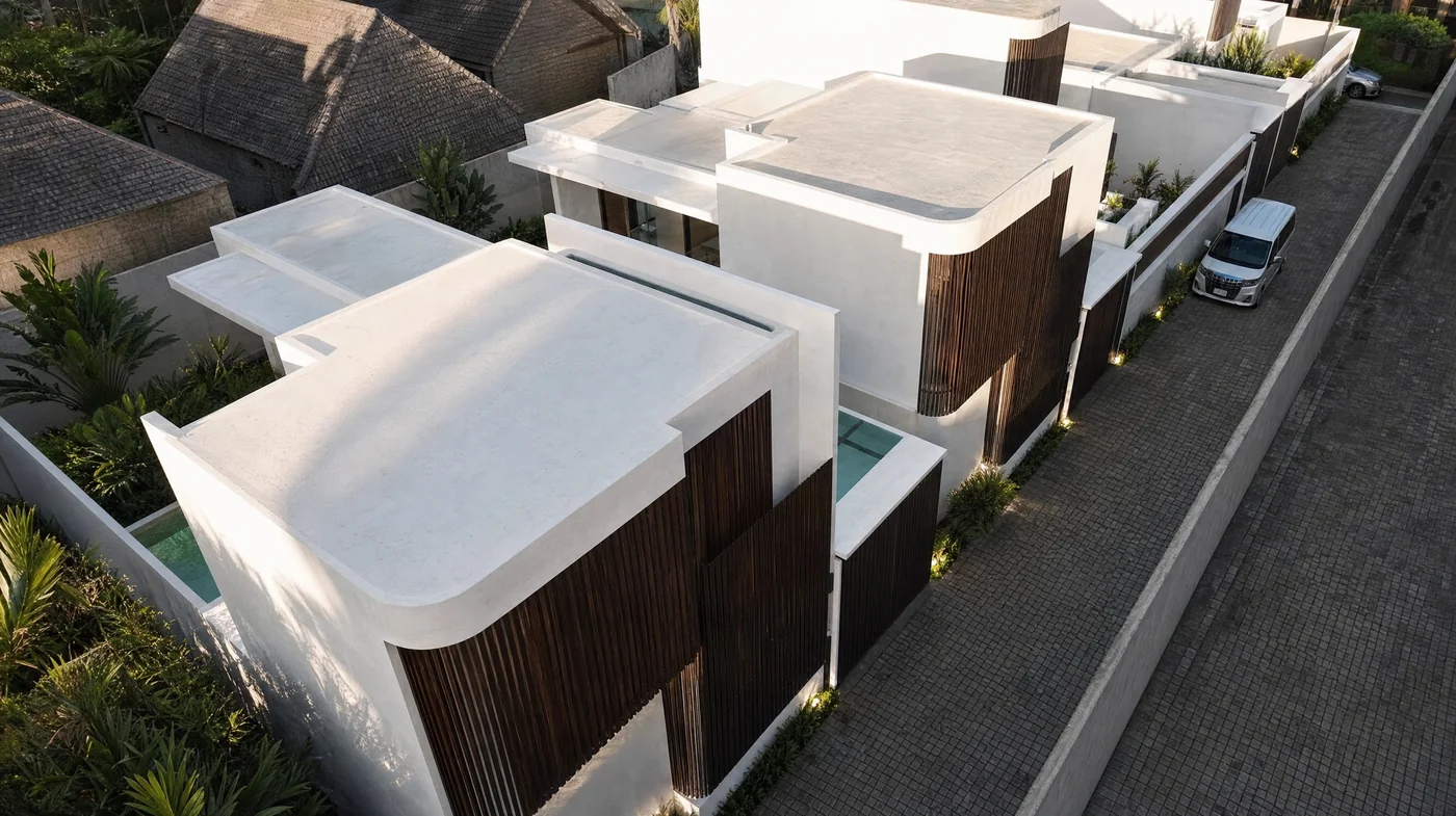 Looking down on the five villas and their pools. Neighbouring roofs sit close on every side.